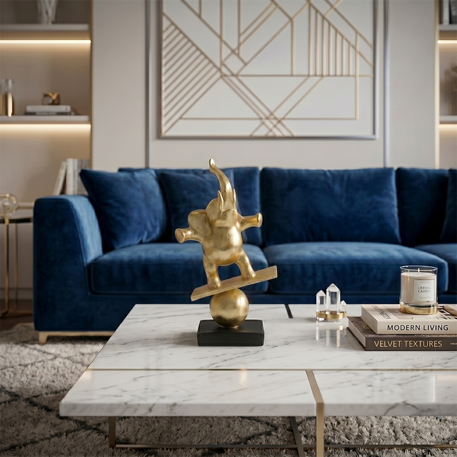 gold balancing elephant on marble coffee table
