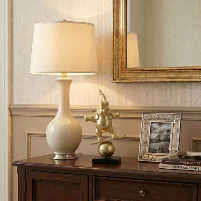 gold balancing elephant on wooden cabinet with lamp
