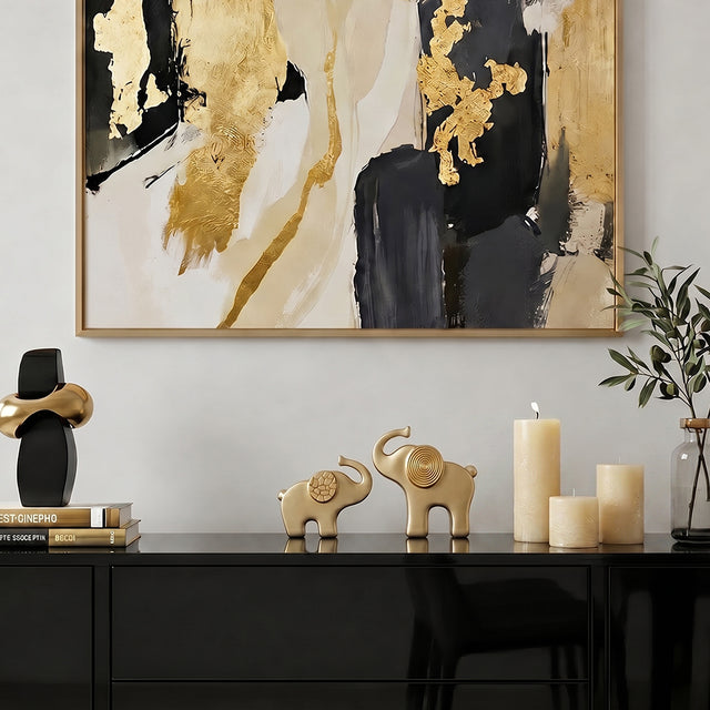 gold elephant sculptures on black cabinet