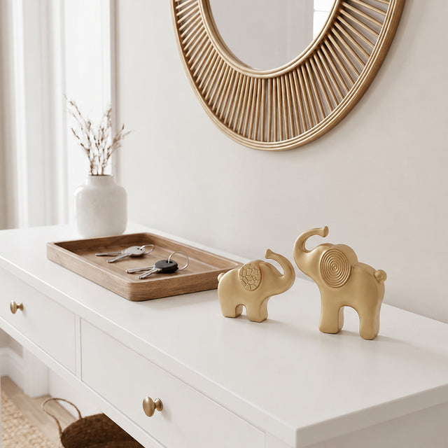 gold elephant sculptures on white console