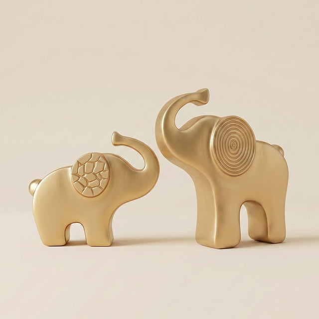 gold elephant sculptures raising trunks