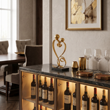 gold love sculpture on bar cabinet wine