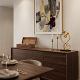 gold love sculpture on dining sideboard candles