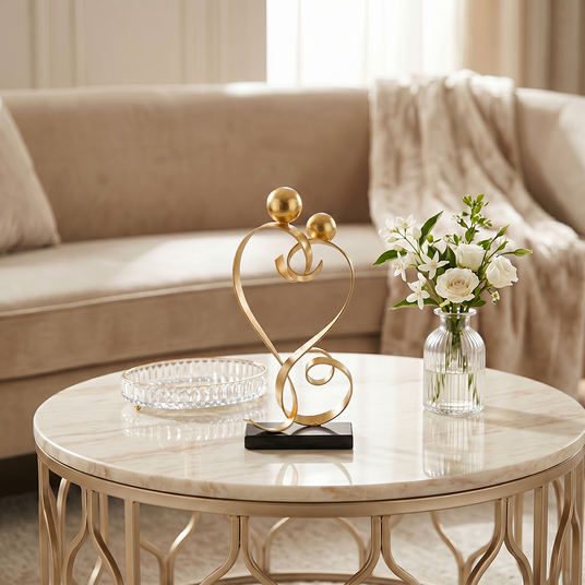 gold love sculpture on round coffee table
