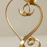 gold love sculpture ribbon curves close up