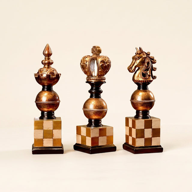 golden chess piece sculptures lineup on beige background
