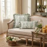 green ruffle pillows on vintage beige sofa