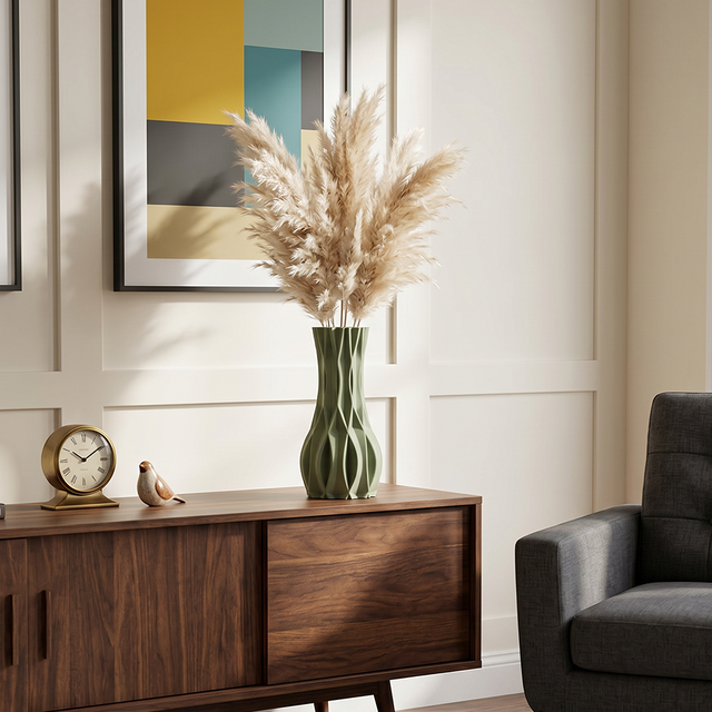 green vase with pampas grass on wooden sideboard
