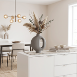 grey vase with pampas grass on dining sideboard