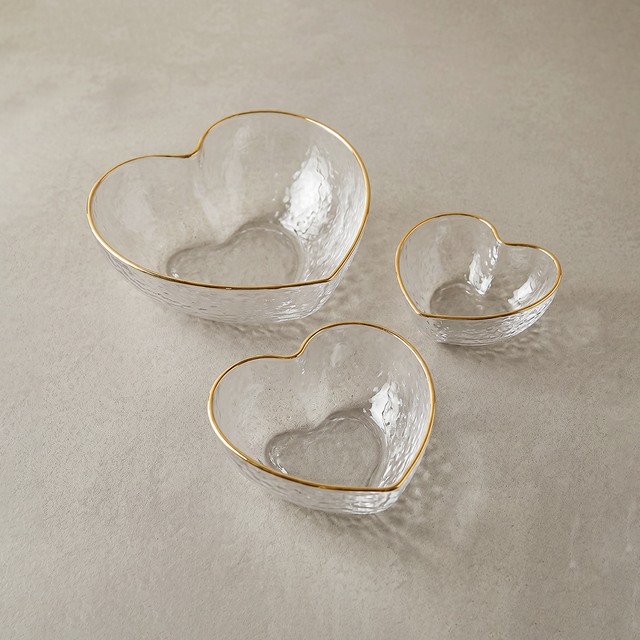 heart shaped glass bowls on beige background