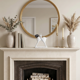 horse and rider sculpture on mantel with mirror and pampas