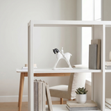 horse and rider sculpture on white bookshelf