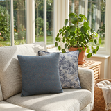 jacquard pillows on beige sofa by sunny window