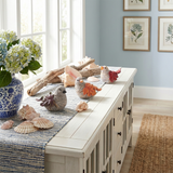 leaf bird sculptures on coastal sideboard with shells