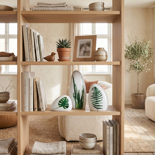 leaf print ceramics on wooden shelf with books