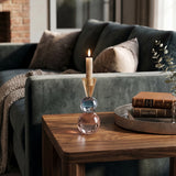 lit colorful crystal candle holder on side table