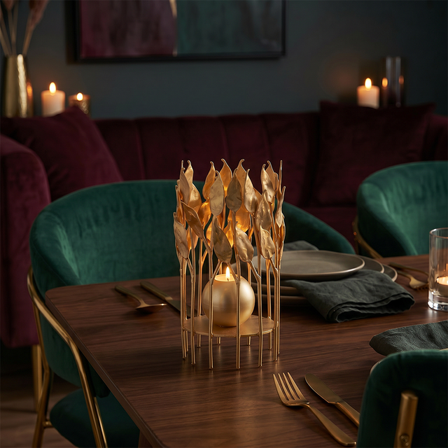 lit gold leaf candle holder on elegant dining table