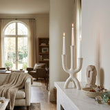 lit textured candle holder on marble sideboard