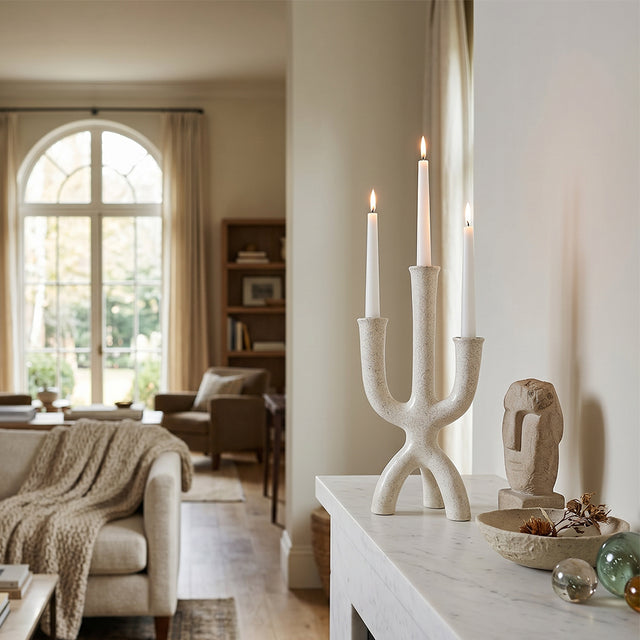 lit textured candle holder on marble sideboard