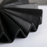 macro shot of black pleated vase folded edge