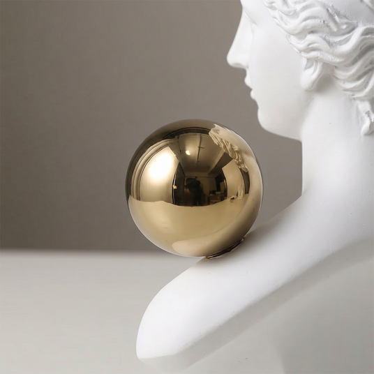 macro shot of shiny gold sphere on shoulder
