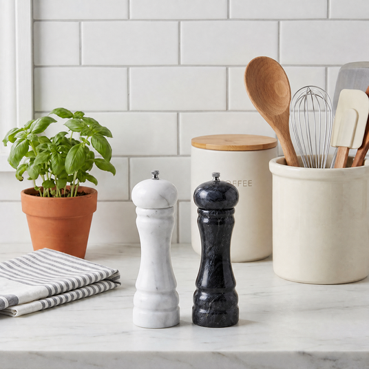marble salt and pepper mills on white kitchen counter