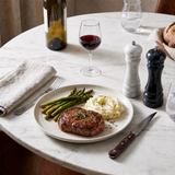 marble salt and pepper mills with steak dinner