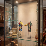 metal musician figurines inside glass display cabinet