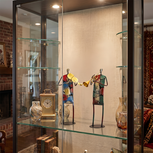 metal musician figurines inside glass display cabinet