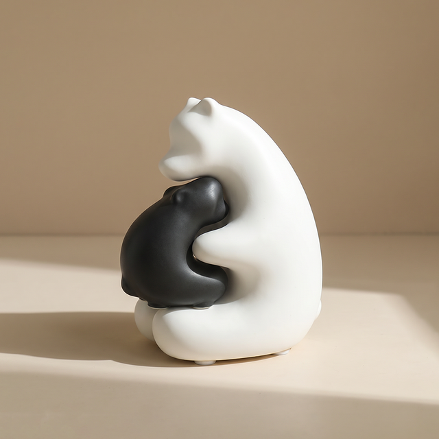 minimalist hugging black and white bear figurine