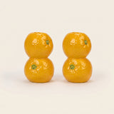 orange candle holder pair on white background