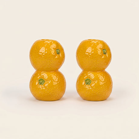 orange candle holder pair on white background