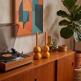 orange candle holders beside record player
