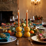 orange candle holders on holiday dining table