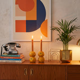 orange candle holders on sideboard