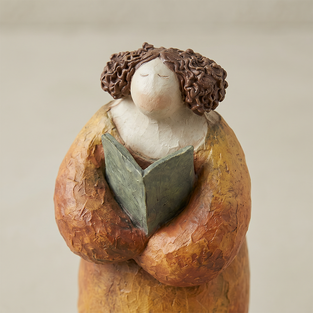 pebble figurine hugging close up