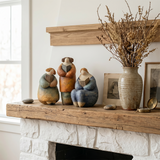 pebble figurine on mantel with dried flowers