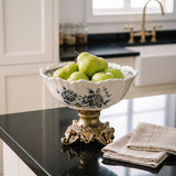 pedestal bowl with green apples on kitchen island