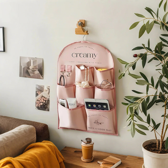 pink fabric storage bag hanging on the wall