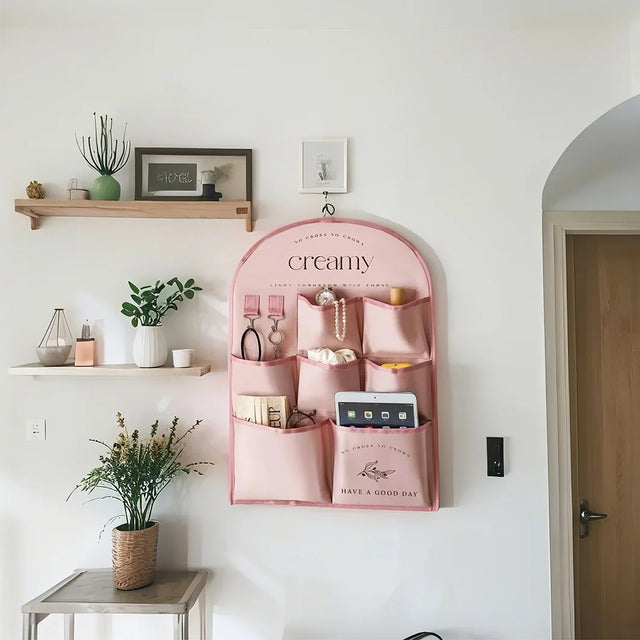 pink fabric storage bag on the wall