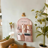 pink fabric storage bag on the wall