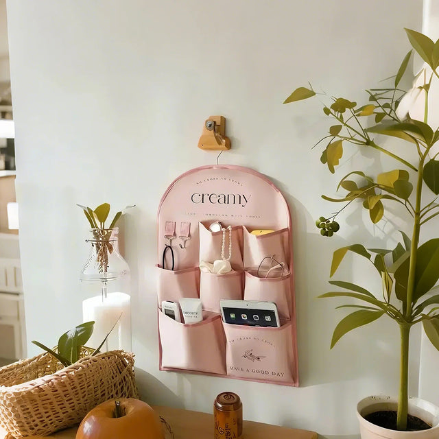 pink fabric storage bag on the wall
