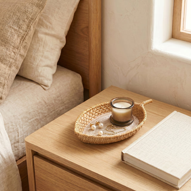 rattan tray with candle and jewelry on bedside
