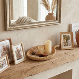 rattan tray with candles on wooden mantel