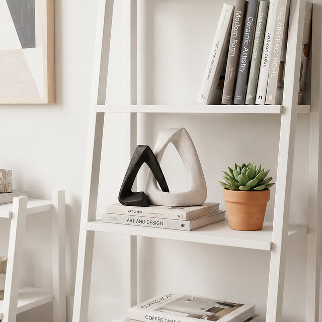 resin sculpture on leaning ladder shelf