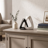 resin sculpture on sideboard with vase