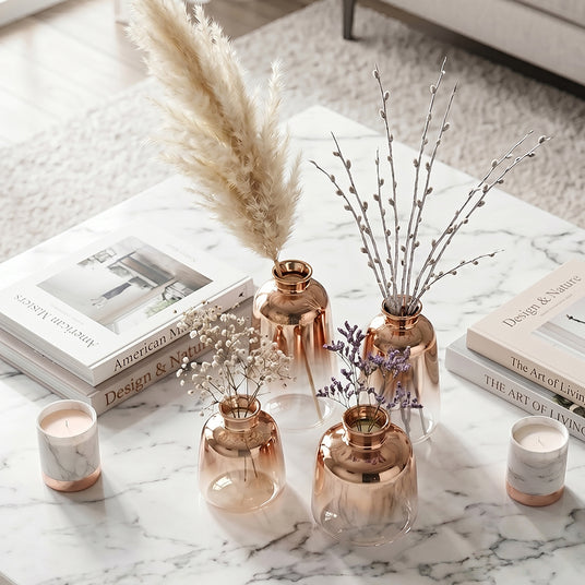 rose gold vases with flowers on coffee table