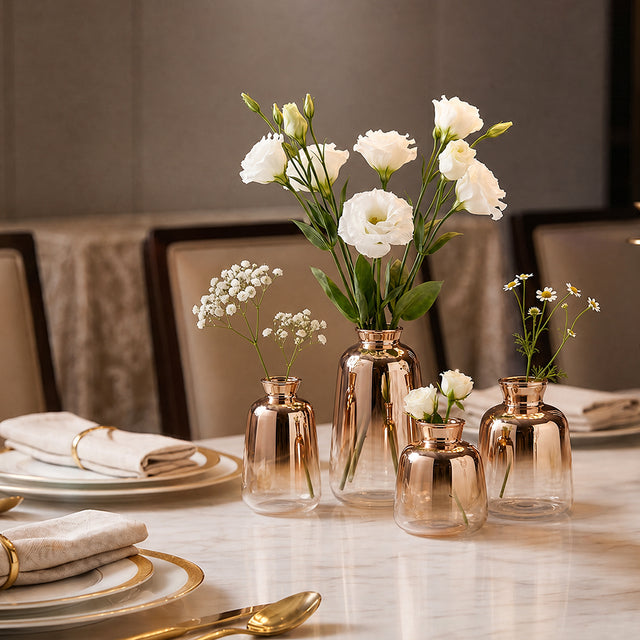 rose gold vases with white flowers on formal table