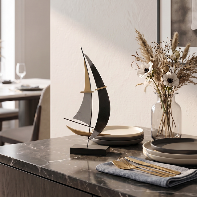 sailboat sculpture on dining table with dried flowers