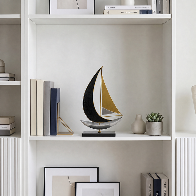 sailboat sculpture on white bookshelf